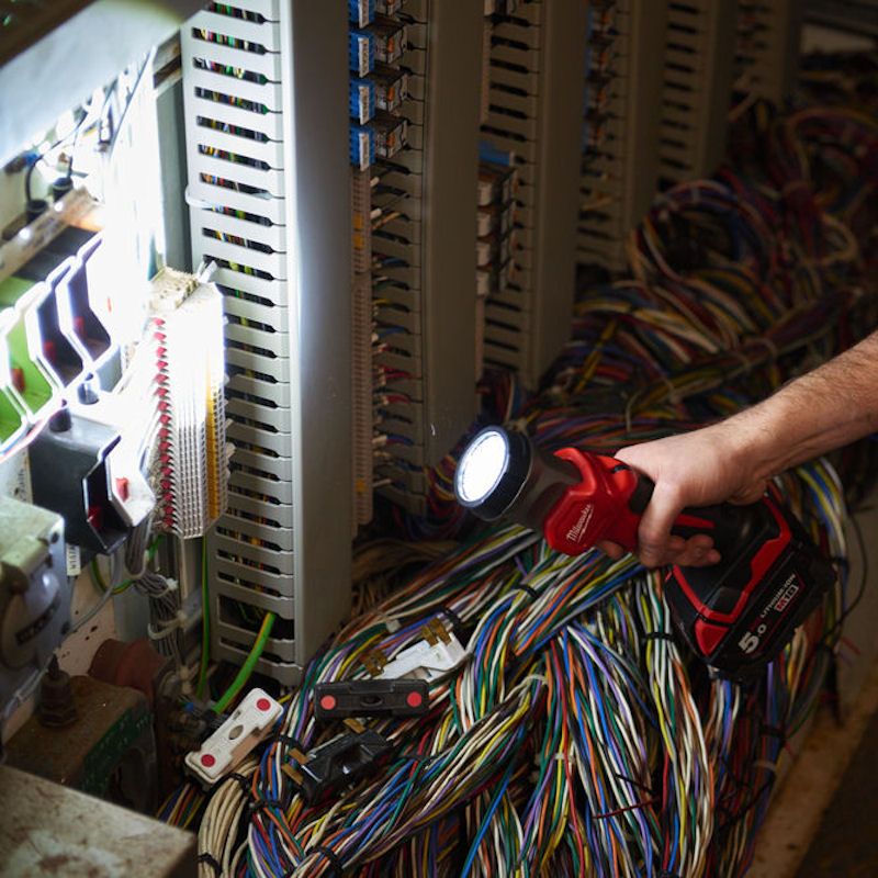Worker using the MILWAUKEE® M18 LED Torch to illuminate a dark room, showcasing its powerful, precise lighting, 120-degree pivoting head, and rugged, portable design for reliable jobsite use. Worker using the MILWAUKEE® M18 LED Torch to illuminate a dark room, showcasing its powerful, precise lighting, 120-degree pivoting head, and rugged, portable design for reliable jobsite use.